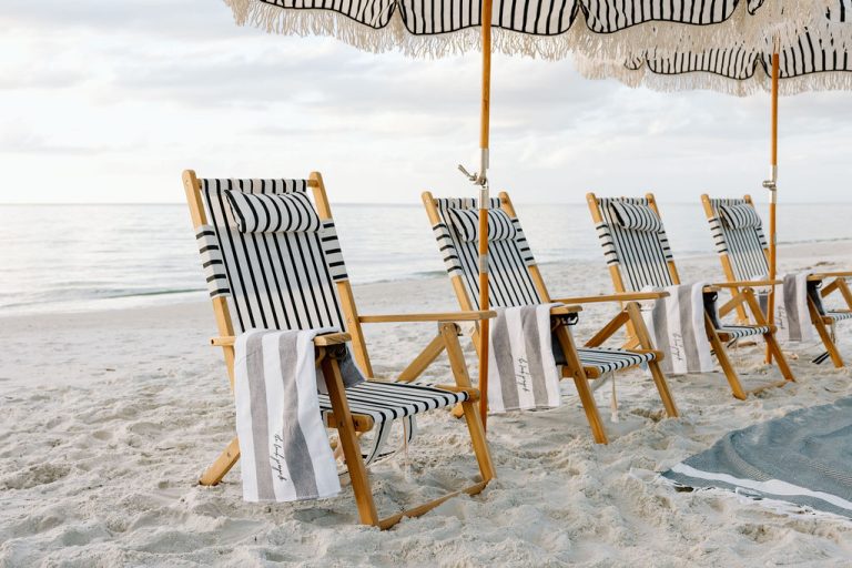 A group beach setup with umbrellas and seating