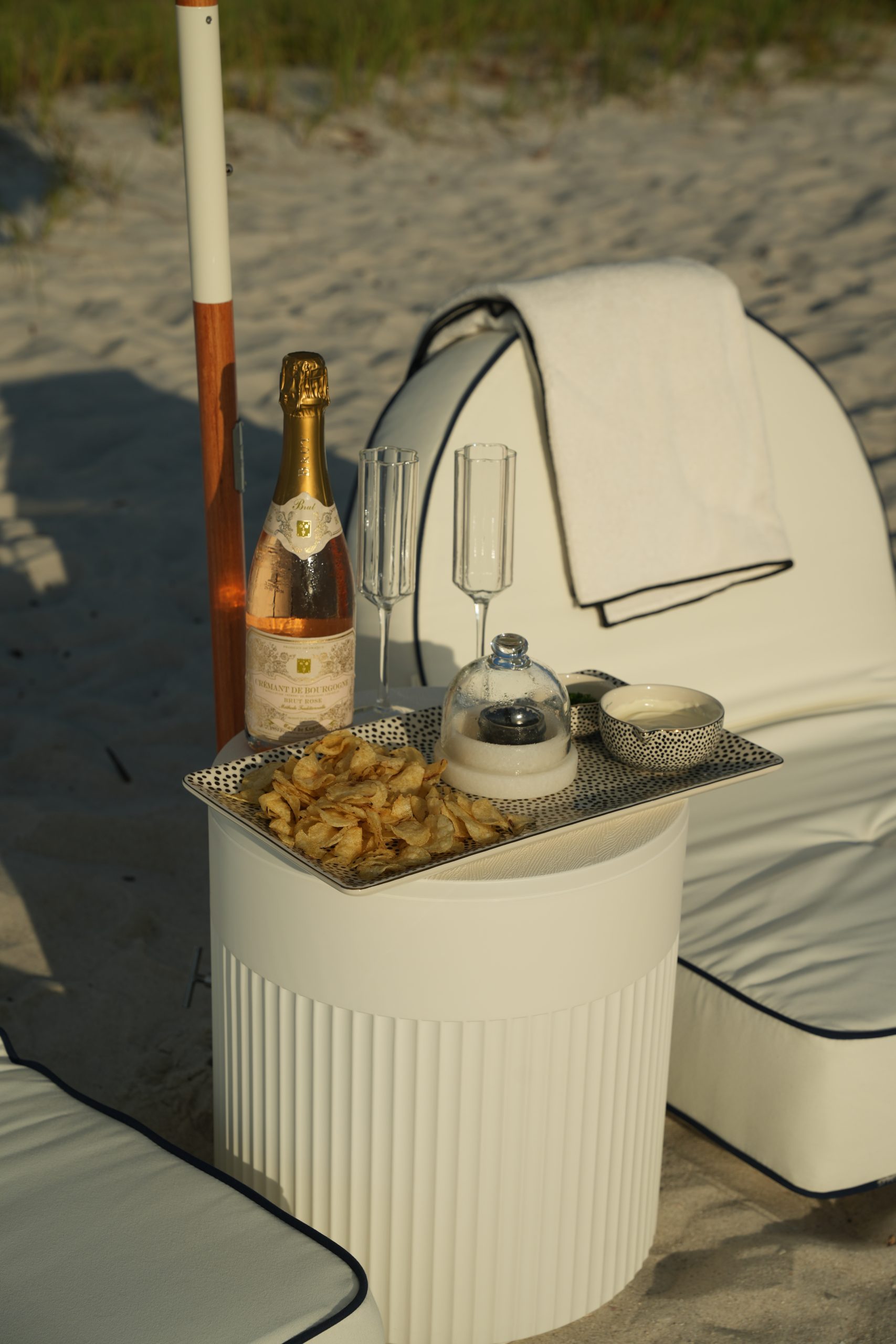 A styled beach setup arranged for a group celebration on the Naples sand