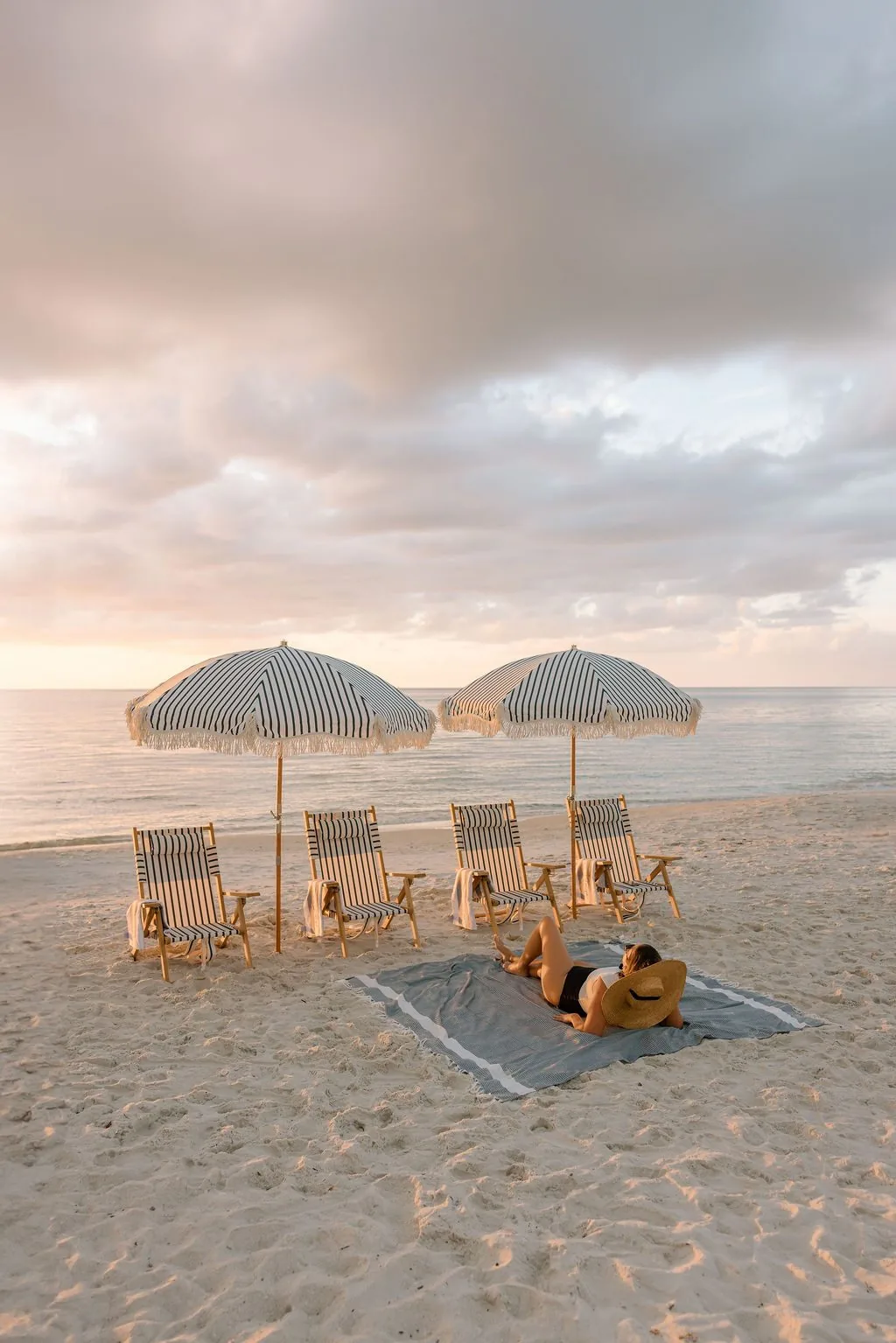 Four striped beach chairs set and ready on the Naples sand